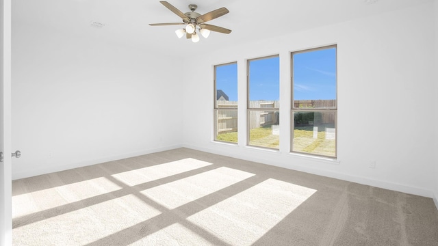 carpeted empty room with ceiling fan