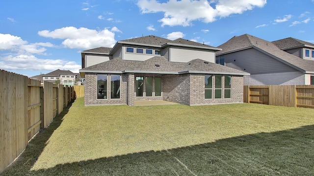 rear view of house with a patio area and a yard