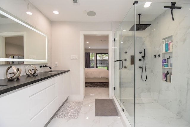 bathroom with a shower with door and vanity