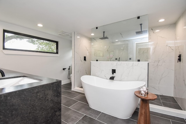 bathroom featuring sink, tile patterned floors, and independent shower and bath