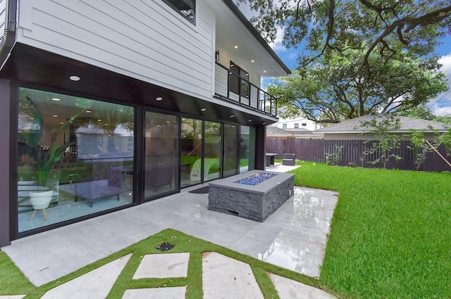 view of yard featuring an outdoor fire pit and a patio