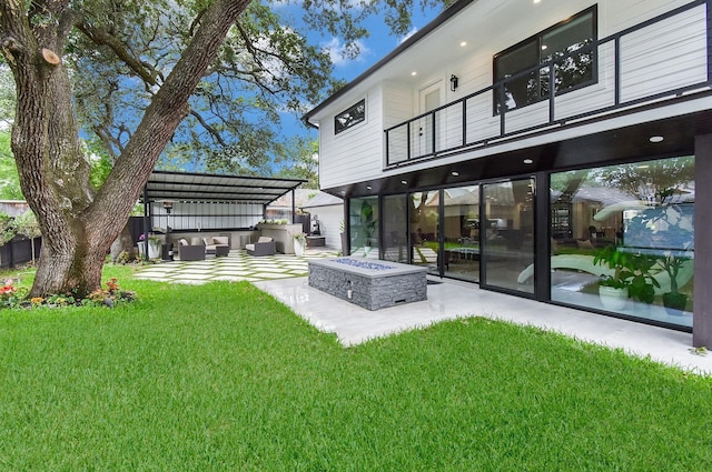 rear view of house featuring a balcony, a patio, a lawn, an outdoor living space with a fire pit, and a pergola