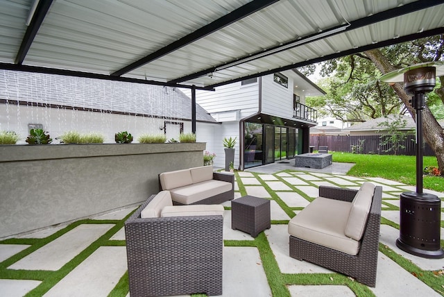 view of patio / terrace featuring an outdoor living space with a fire pit