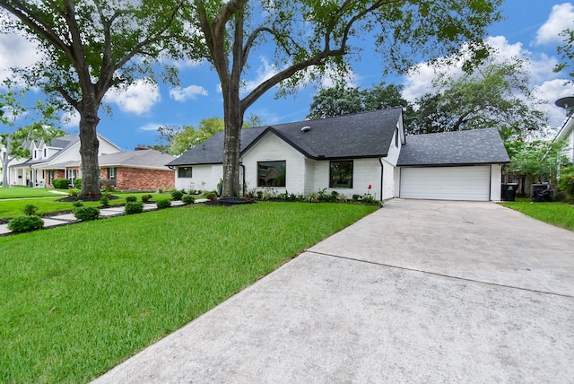 view of front of house with a front yard and a garage