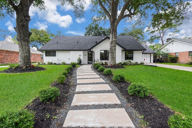 view of front of property featuring a garage and a front yard