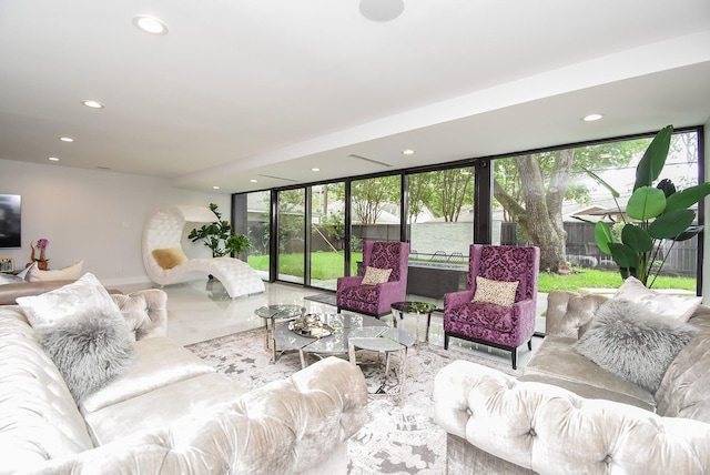 living room featuring a wall of windows and a water view