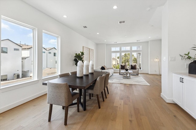 dining area featuring baseboards, light wood finished floors, visible vents, and recessed lighting