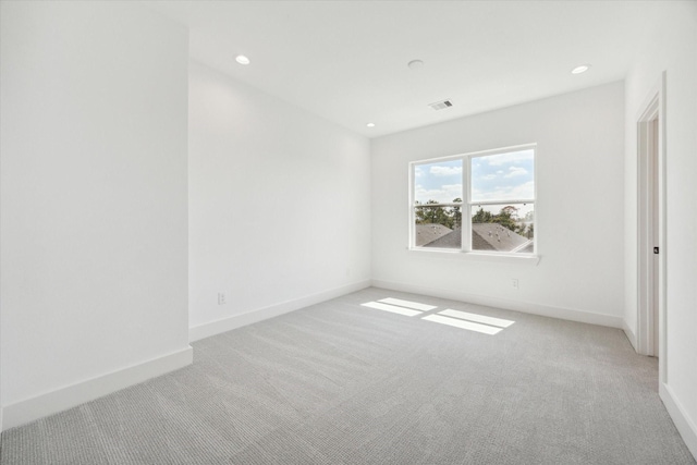 unfurnished room with baseboards, recessed lighting, visible vents, and light colored carpet