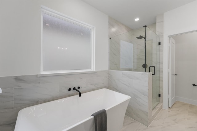 bathroom with separate shower and tub