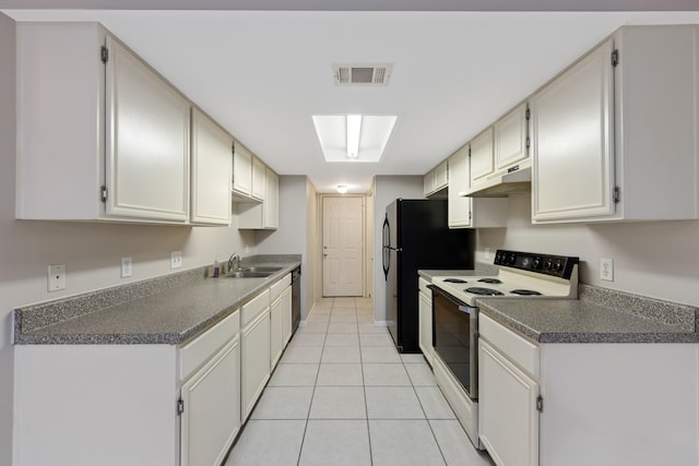 kitchen featuring black appliances, white cabinetry, a skylight, sink, and light tile patterned floors