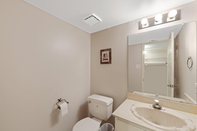 bathroom featuring toilet and vanity