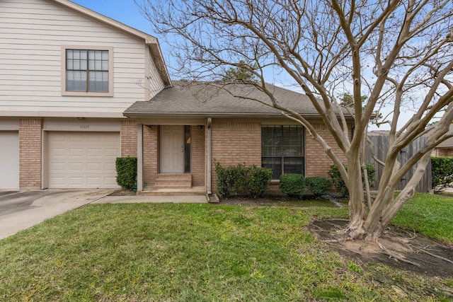 view of front of home with a garage and a front lawn