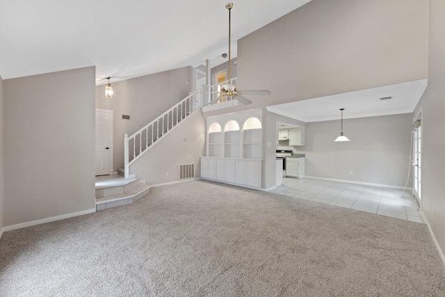 unfurnished living room featuring ceiling fan and light carpet