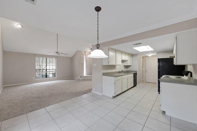 kitchen featuring ceiling fan, vaulted ceiling, pendant lighting, white cabinetry, and light carpet