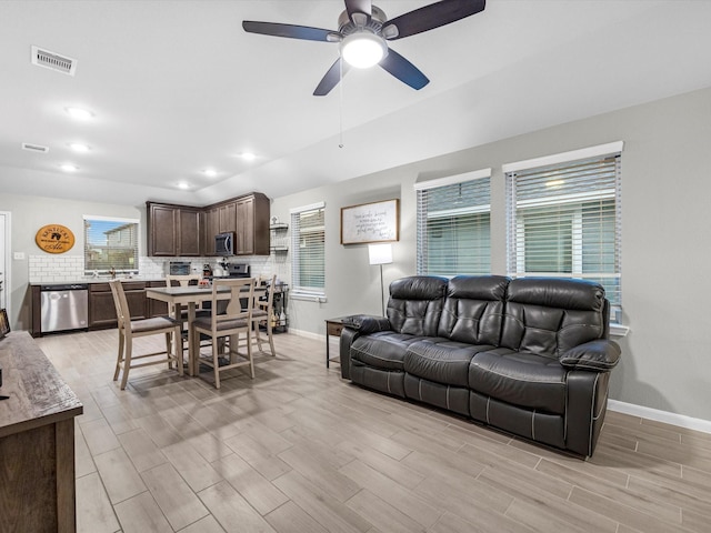 living room with ceiling fan and a wealth of natural light