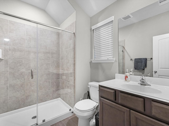 bathroom featuring a shower with door, vaulted ceiling, vanity, and toilet