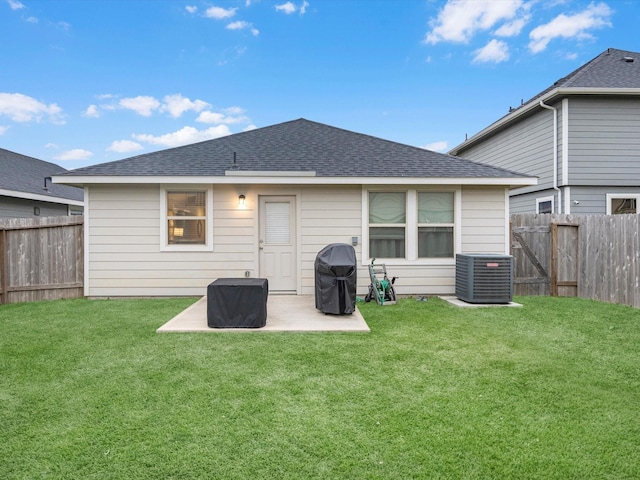 rear view of house featuring a patio, a yard, and central air condition unit