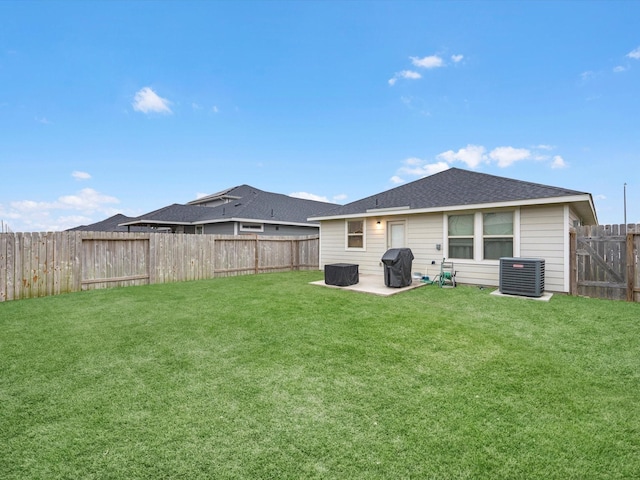 back of house featuring cooling unit, a yard, and a patio area