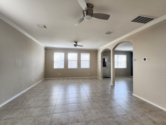 spare room with ceiling fan, light tile patterned floors, and ornamental molding