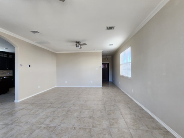 tiled spare room featuring ceiling fan and crown molding