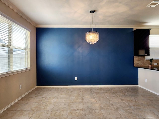 unfurnished dining area with light tile patterned floors, an inviting chandelier, and crown molding