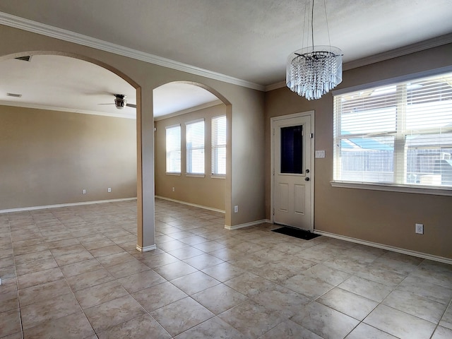 foyer entrance featuring ceiling fan with notable chandelier, light tile patterned floors, and crown molding