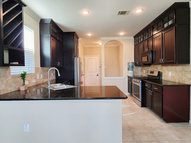 kitchen featuring kitchen peninsula, sink, stainless steel appliances, and dark brown cabinetry