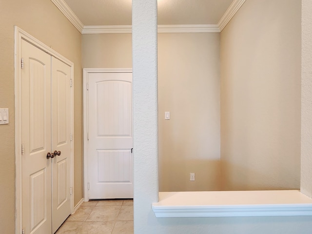 hallway with light tile patterned floors and crown molding