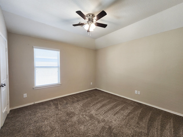 carpeted empty room featuring vaulted ceiling and ceiling fan