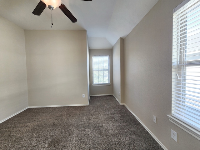 carpeted spare room featuring ceiling fan and lofted ceiling