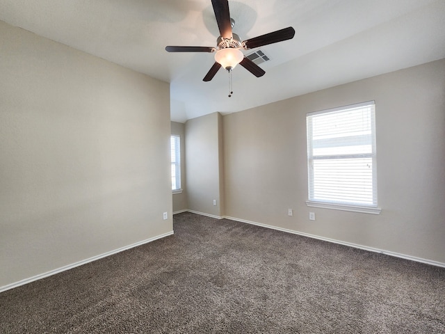 carpeted spare room featuring ceiling fan