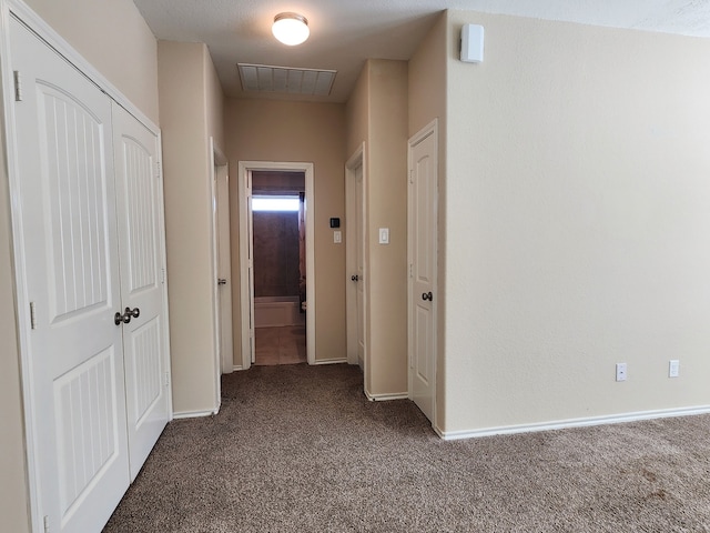 corridor with dark carpet