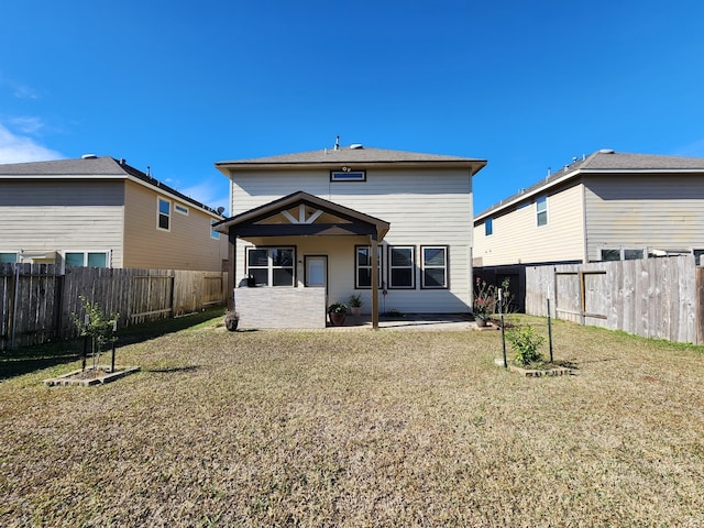 rear view of property with a yard and a patio