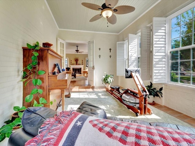 interior space featuring brick wall, light tile patterned flooring, and ornamental molding