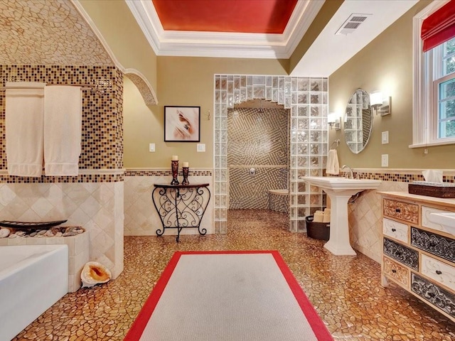 bathroom featuring tile walls, a washtub, and ornamental molding