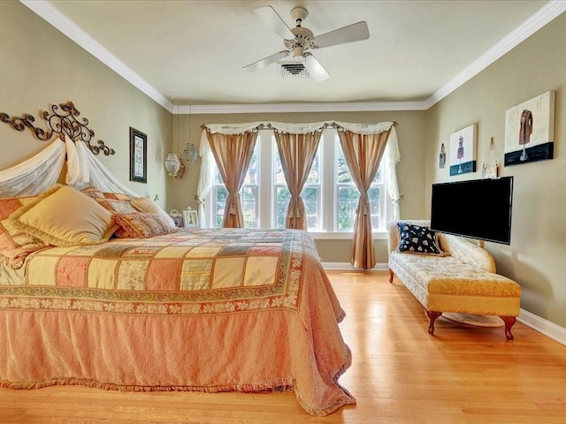 bedroom featuring hardwood / wood-style flooring, ceiling fan, and ornamental molding