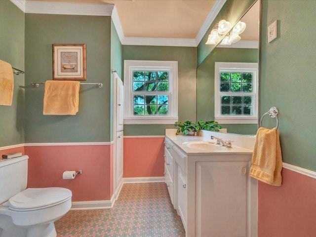 bathroom featuring toilet, crown molding, a wealth of natural light, and vanity