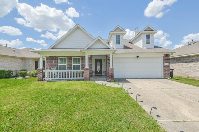 view of front of property featuring a porch, a front yard, and a garage