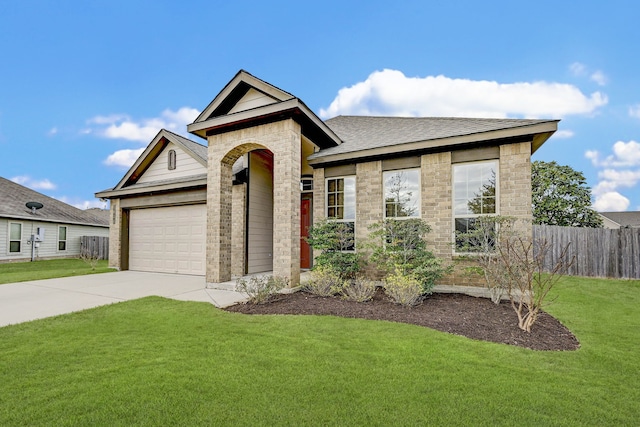 view of front of house with a front yard and a garage