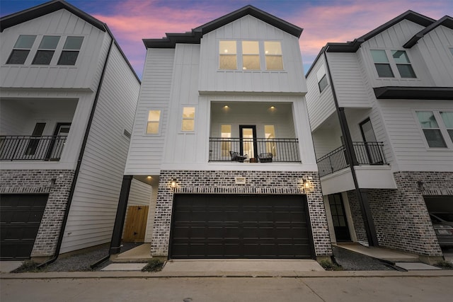 view of property featuring a balcony and a garage