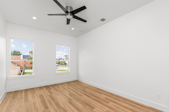 spare room featuring light hardwood / wood-style floors and ceiling fan