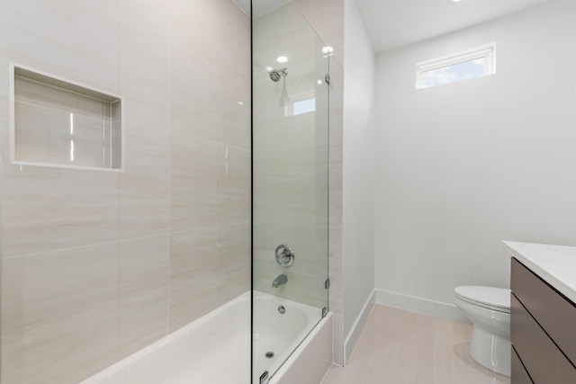 full bathroom featuring tile patterned floors, toilet, vanity, and tiled shower / bath