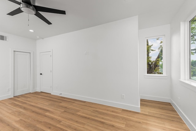 empty room featuring ceiling fan and light hardwood / wood-style flooring