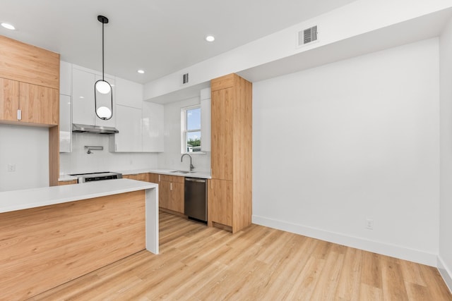 kitchen with sink, white cabinets, decorative light fixtures, stainless steel dishwasher, and tasteful backsplash