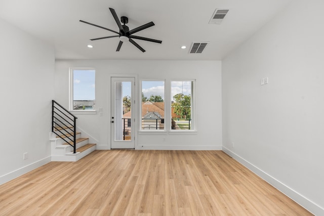 unfurnished living room featuring ceiling fan and light hardwood / wood-style flooring