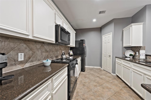 kitchen with black / electric stove, backsplash, white cabinets, dark stone counters, and light tile patterned flooring