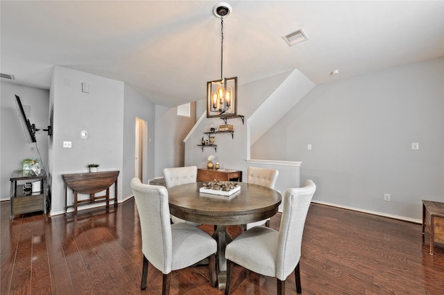 dining space with a notable chandelier and dark hardwood / wood-style flooring