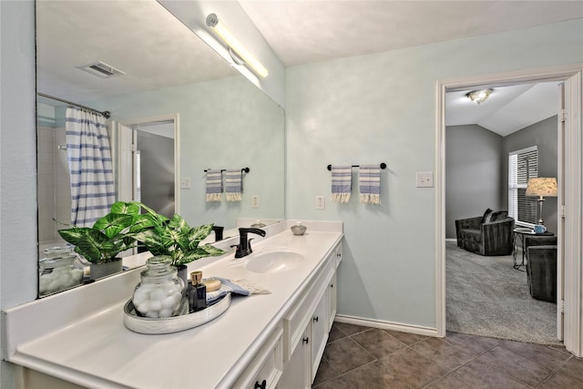 1211 Ennis St, Houston, TX 77003 - bathroom featuring vanity, tile patterned flooring, baseboards, curtained shower, and vaulted ceiling