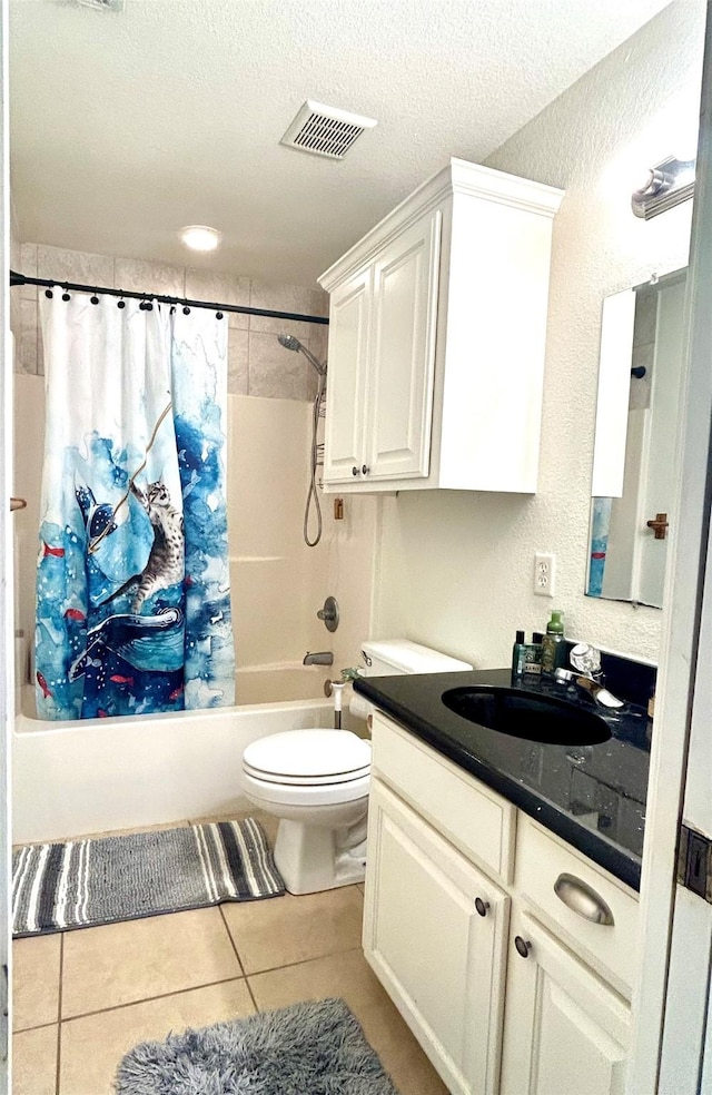 full bathroom featuring toilet, a textured ceiling, shower / bath combination with curtain, tile patterned floors, and vanity