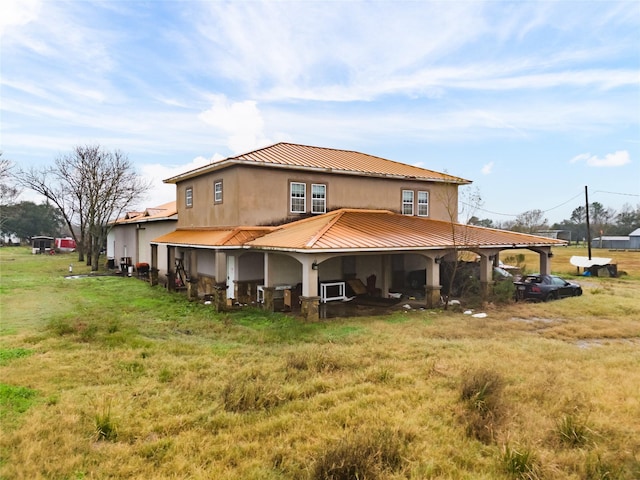 back of property featuring a lawn